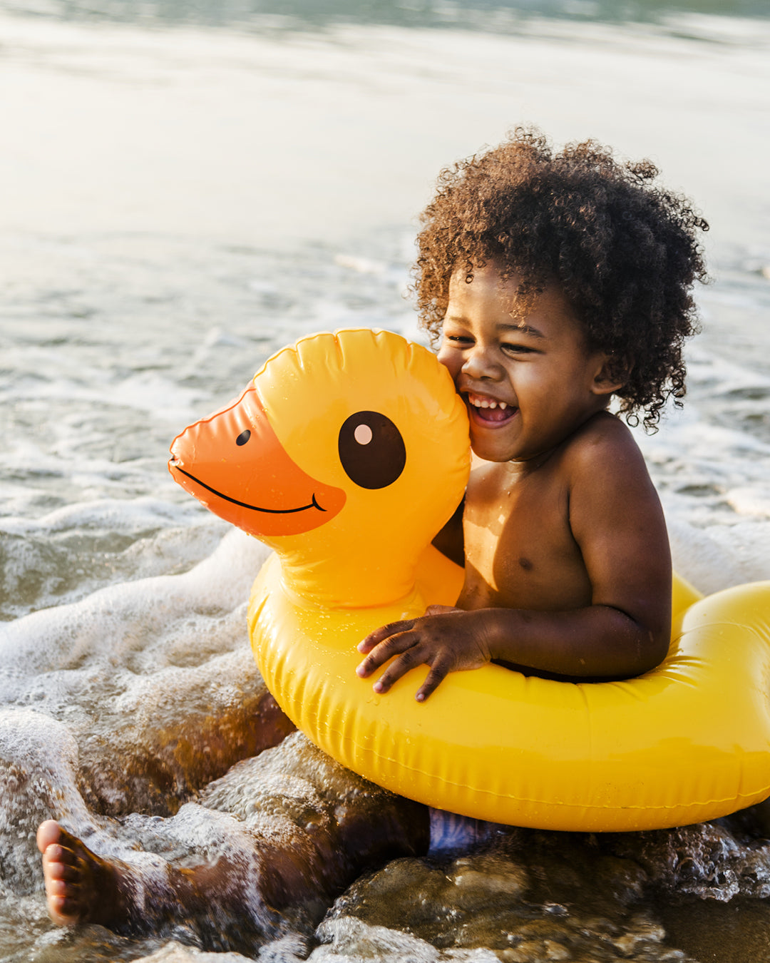 Toddler in yellow duck floatie